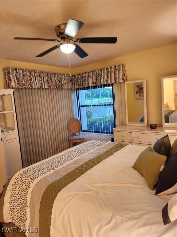 Carpeted bedroom with ceiling fan