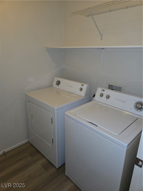 Laundry area featuring washer and dryer and dark wood finished floors