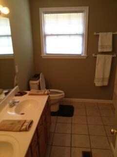 Hall bathroom with Hollywood lighting over double sinks