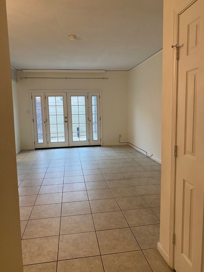 View of family room from foyer. Door to the right is storage space under the stairs.