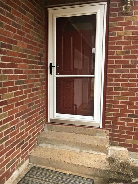 Front entry door and storm door are new additions.