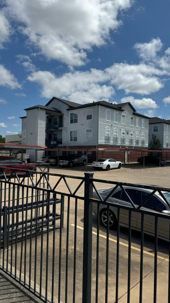 This photo shows a multi-story apartment complex w