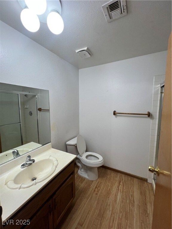 Bathroom with wood finished floors, a shower stall