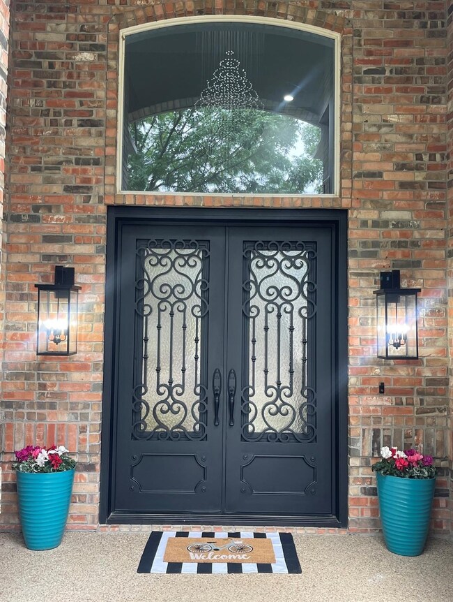 Foyer featuring ornate columns, hardwood / wood-st