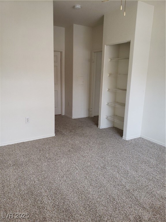 Unfurnished bedroom featuring carpet, baseboards,