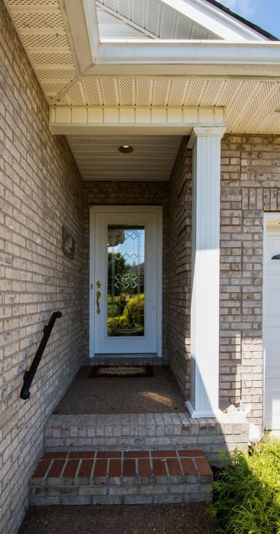 Two steps up to the front entrance of this one level home
