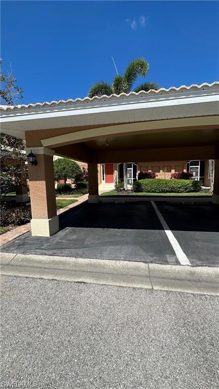 View of parking / parking lot with a carport