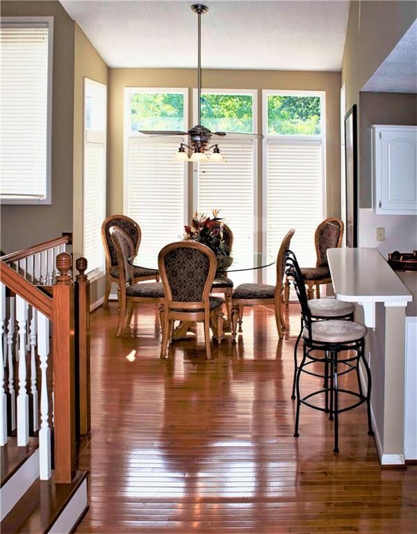 Gleaming hardwoods and tall windows let the sunshi