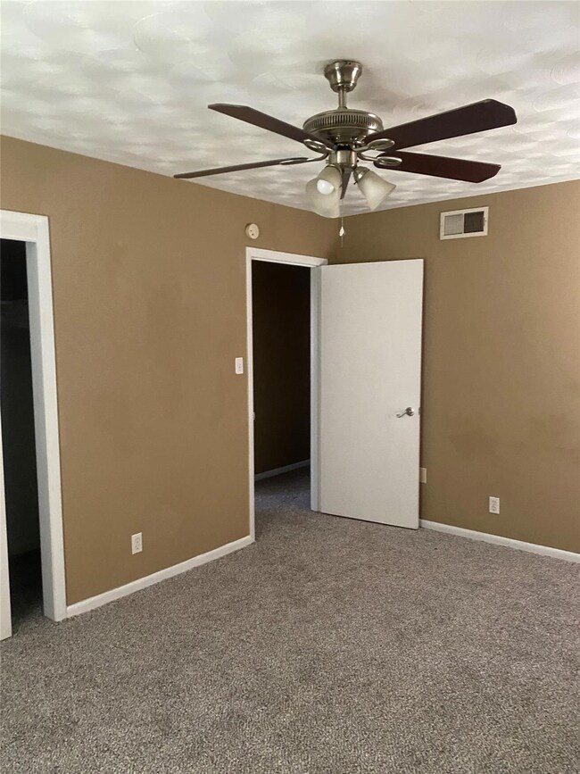 Unfurnished bedroom with carpet flooring, baseboar