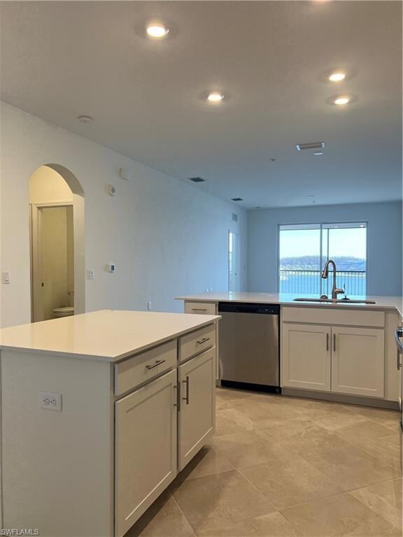 Kitchen featuring a center island, light counterto