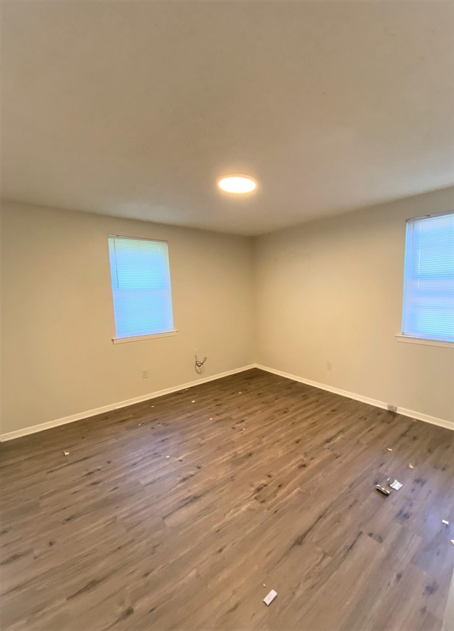 Unfurnished room featuring dark hardwood / wood-st
