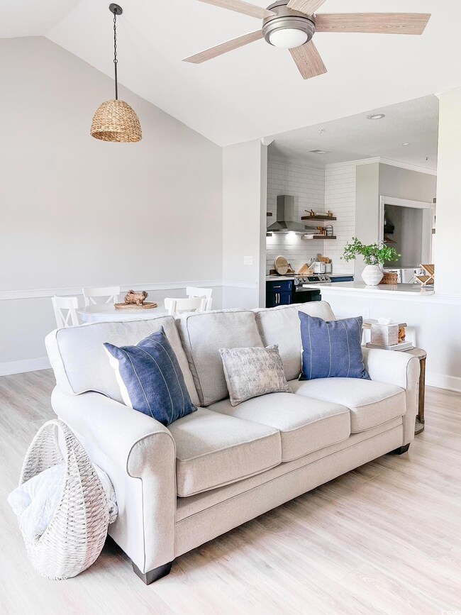Living room featuring lofted ceiling, light hardwo
