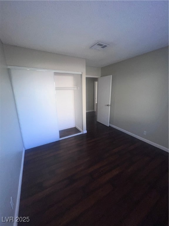 Unfurnished bedroom with visible vents, baseboards