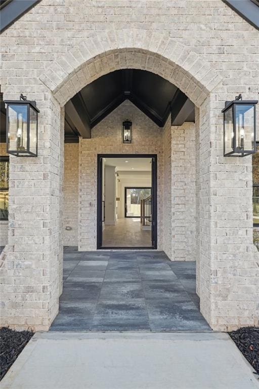 Doorway to property with brick siding
