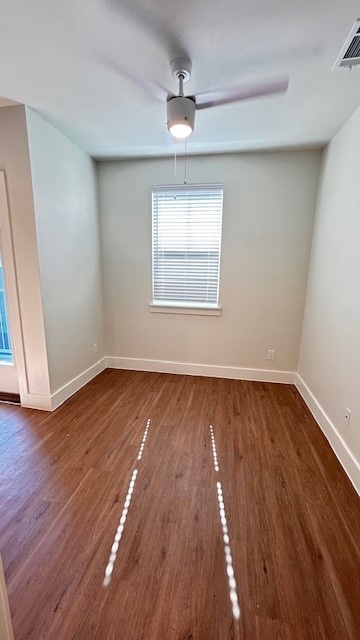 Unfurnished room with dark wood-style flooring