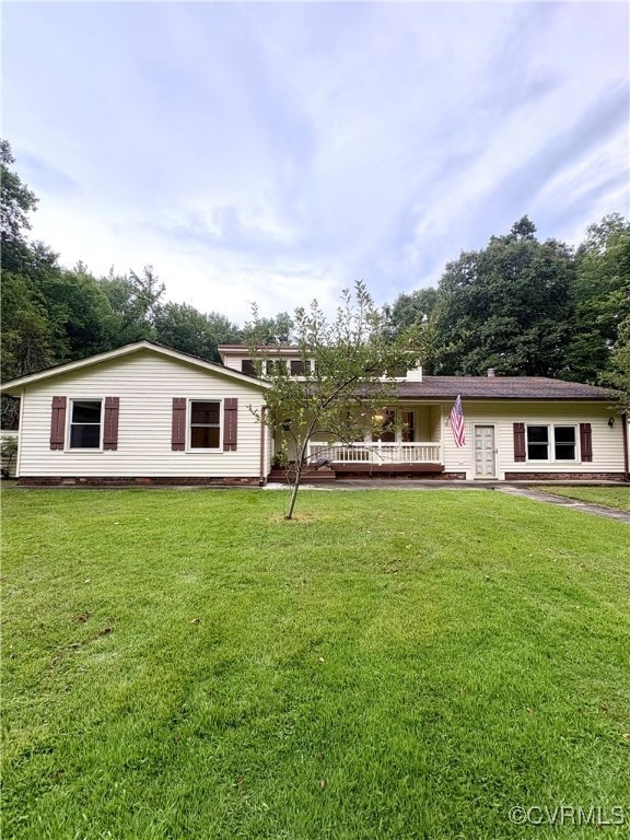 View of front of house with french doors, a front lawn, and a wooden deck