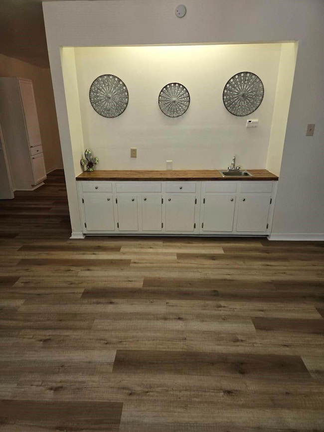 Dining area has a wet bar with lots of cabinets, c