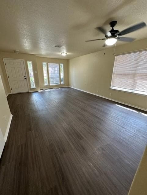 Unfurnished living room with a textured ceiling, 