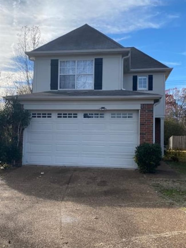 View of front facade featuring an attached garage and concrete driveway