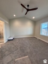 Spare room with vaulted ceiling and carpet