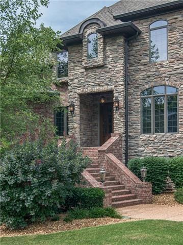 The home is a classic brick and stone design with mature, well maintained landscaping.