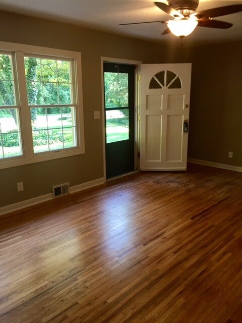 Spacious area with hardwood floors, new ceiling fa