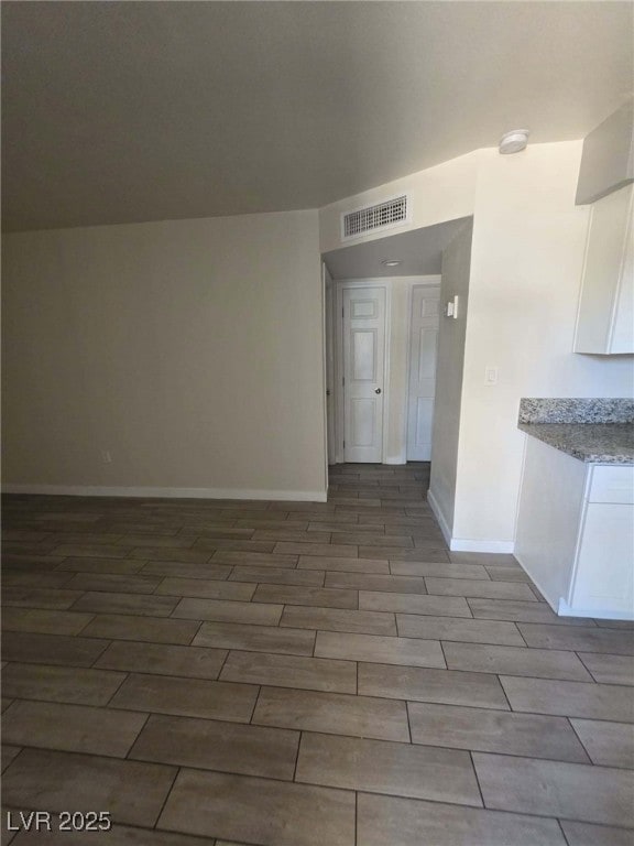 Spare room with wood tiled floors, baseboards, and