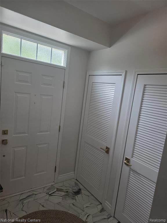 Entryway with light marble finish flooring