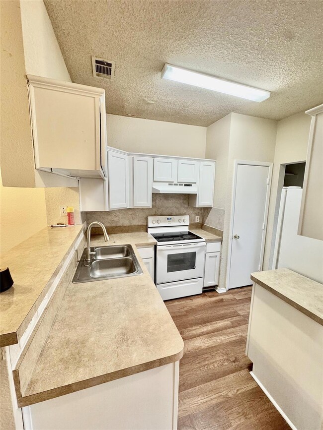 Kitchen featuring visible vents, under cabinet ran