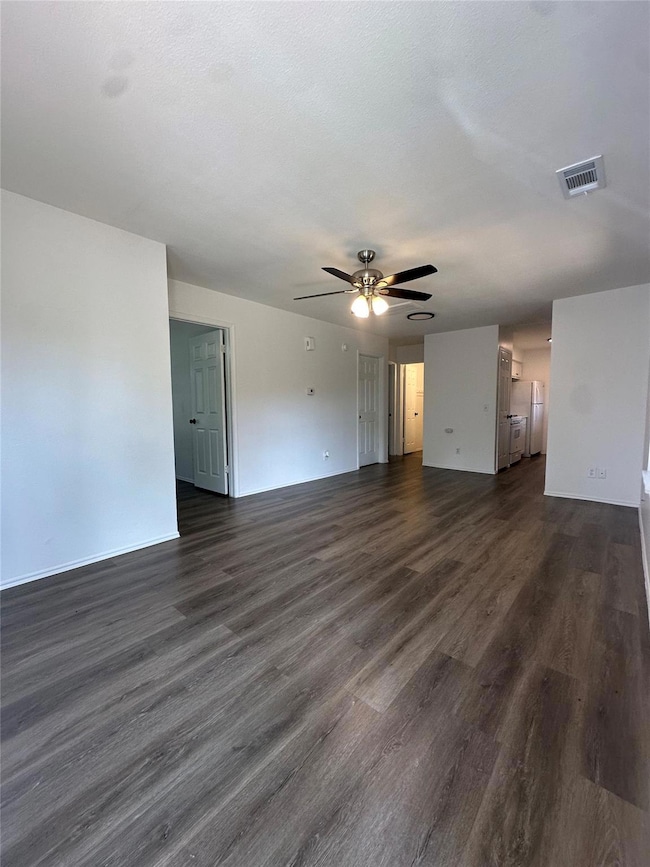 Unfurnished room with dark wood-style flooring an