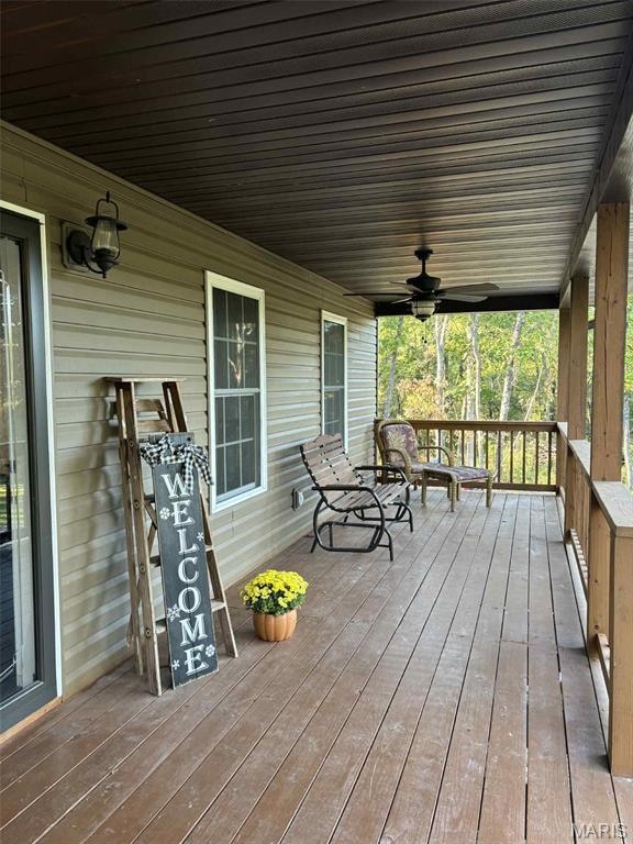 Wooden porch with a ceiling fan