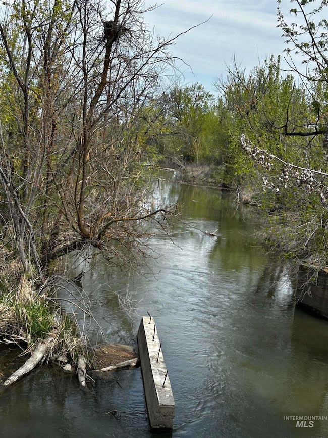 Dock area with a water view and a wooded view