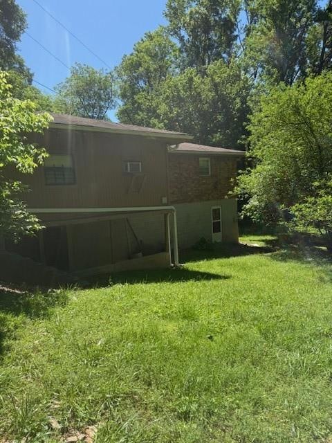 Rear view of house with a yard