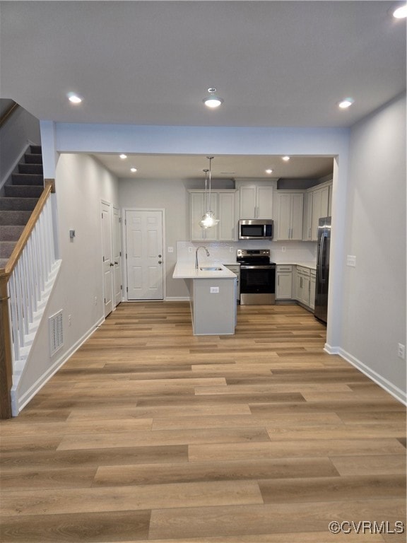 Kitchen featuring a sink, stove, visible vents, li