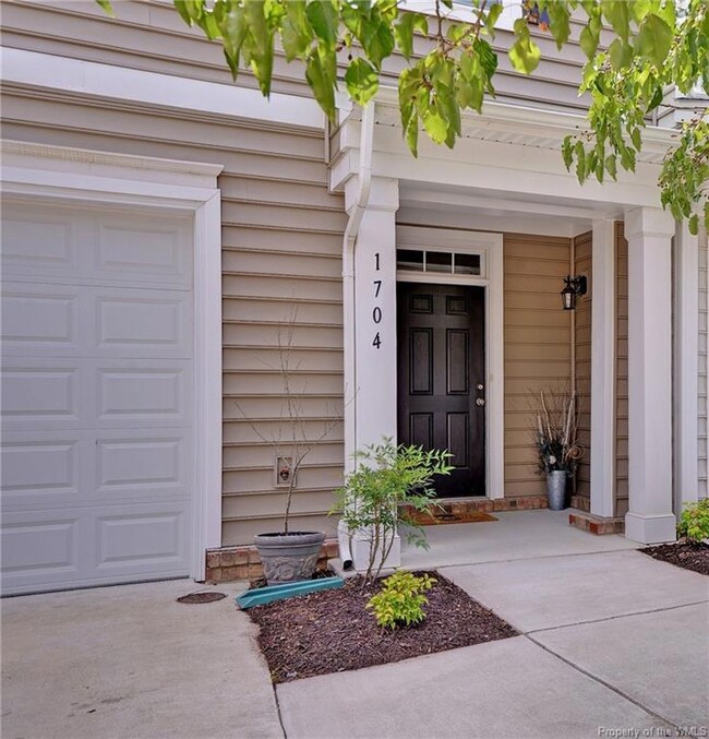Inviting entrance with single car garage.