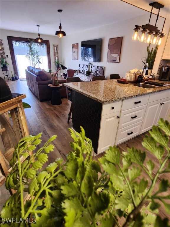 Kitchen featuring light stone counters, decorative