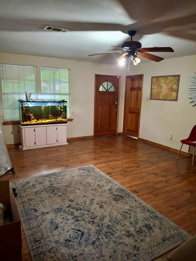 Entryway featuring a ceiling fan, baseboards, and