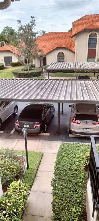 Carport steps away from  the stairs to to the cond