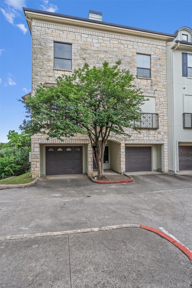 Townhome / multi-family property featuring drivew