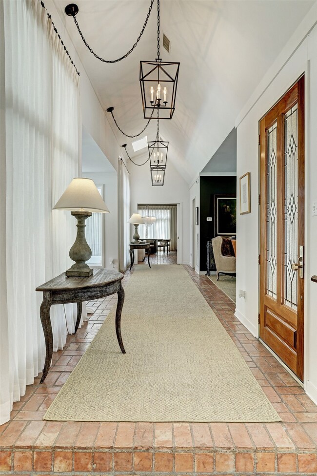 Lanterns line the vaulted ceiling hallway upon ent