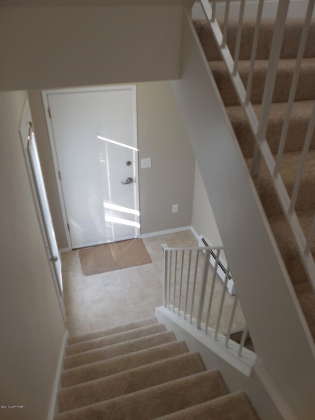 Entry way with door to fenced yard