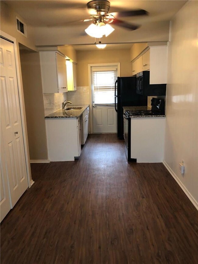 Kitchen with ceiling fan, dark wood finished floor