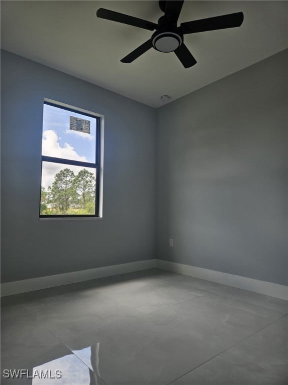 Empty room featuring baseboards and ceiling fan