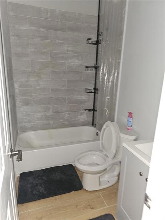 Bathroom featuring vanity, shower / bath combo with shower curtain, and tile patterned floors