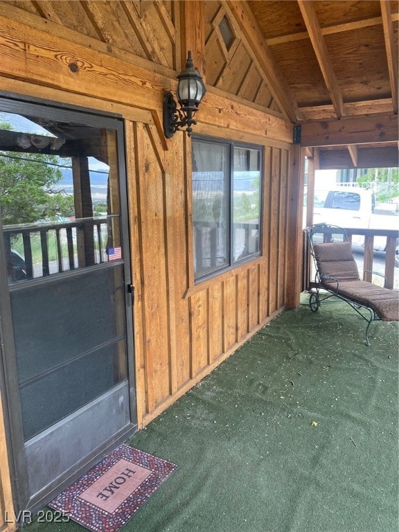 Property entrance featuring board and batten sidin