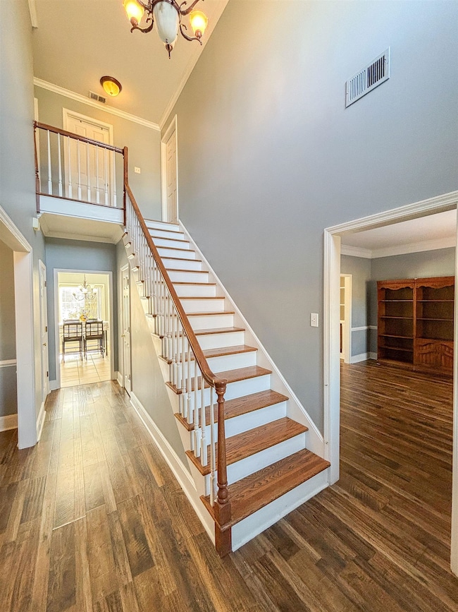 Staircase featuring hardwood / wood-style flooring
