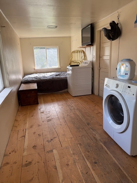 Laundry area with washer / dryer and light wood finished floors