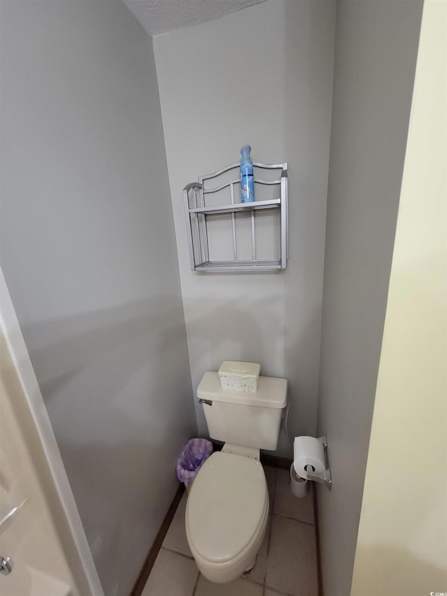 Bathroom featuring toilet and tile patterned floors