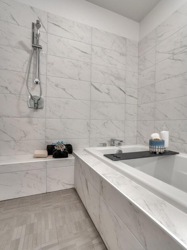 Bathroom featuring tile walls, tile patterned floo