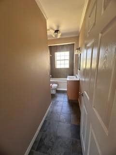 Bathroom with vanity, toilet, and crown molding